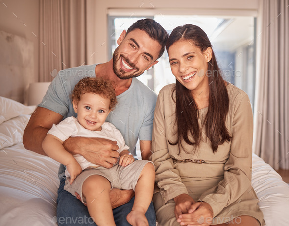 Mom, dad and baby on bed with smile in room together on holiday or vacation in Miami. Parents, bedr