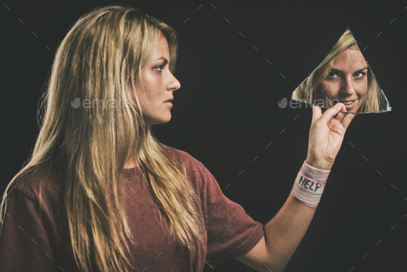 Suicide, mental health and mirror with a woman looking at her reflection in a piece of glass in stu