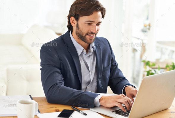 Hell do whatever it takes to get the job done. A handsome businessman working on his laptop.