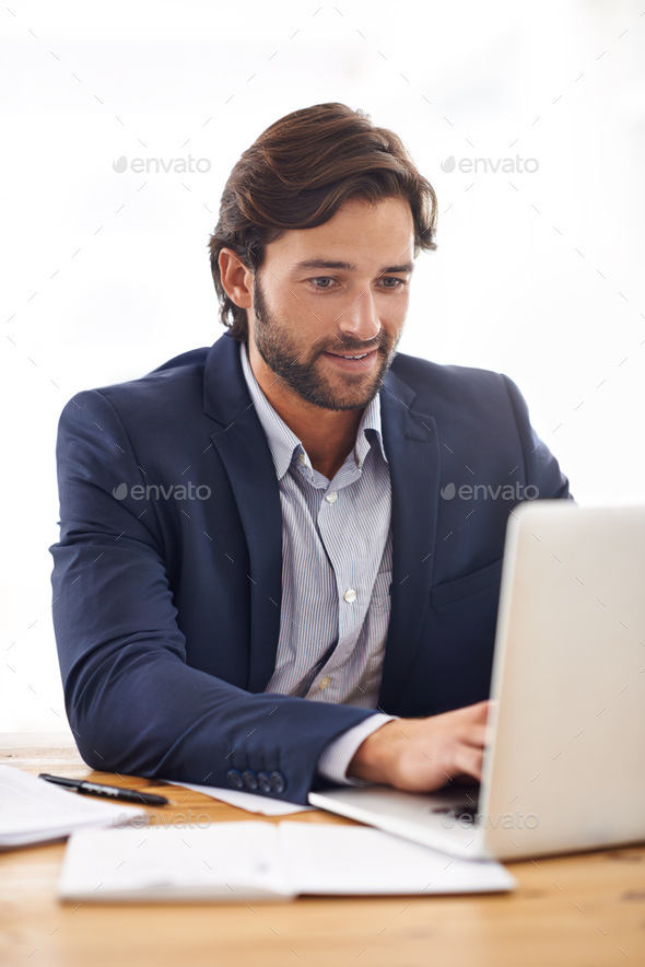 Hell do whatever it takes to get the job done. A handsome businessman typing on his laptop.