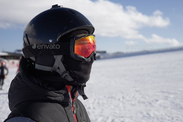 Girl or boy in ski helmet, sunscreen mask and balaclava close up