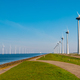 Windmill turbines at sea a huge winmill park in the Netherlandswit a blue sky - PhotoDune Item for Sale