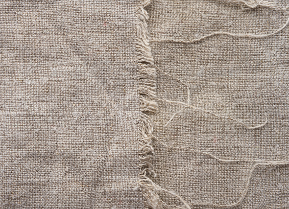 Gray linen fabric with frayed edges with thread