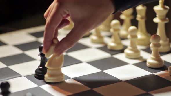 Chess match, with white knight capturing the black pawn