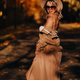 Sexy girl in a coat and hat in an autumn sunny park - PhotoDune Item for Sale