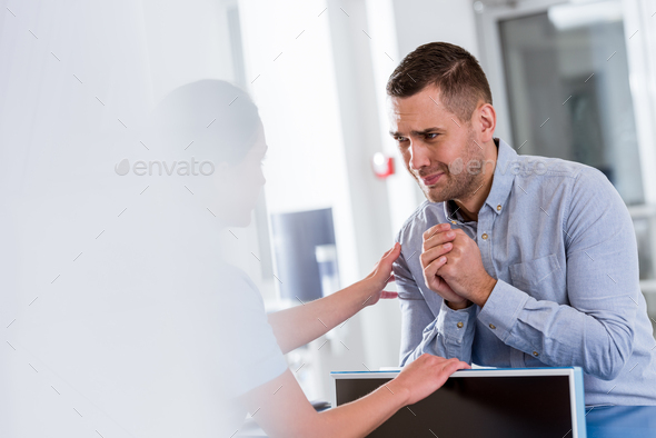 Upset patient looking at nurse with please gesture