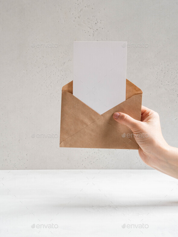 Hand hold open envelope