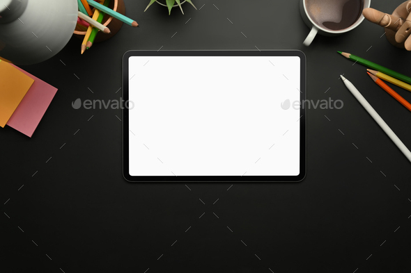 Creative designer workspace with digital tablet, sticky notes and