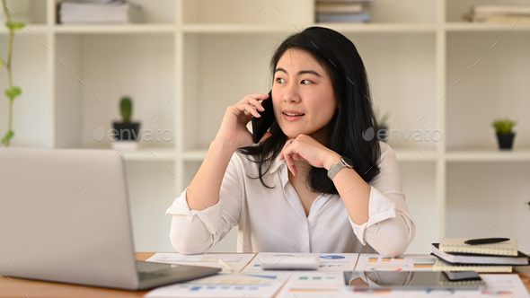 Asian woman female advisor having phone conversation, negotiations with business partner.