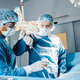 nurse and surgeon in uniforms and medical masks doing operation in operating room - PhotoDune Item for Sale