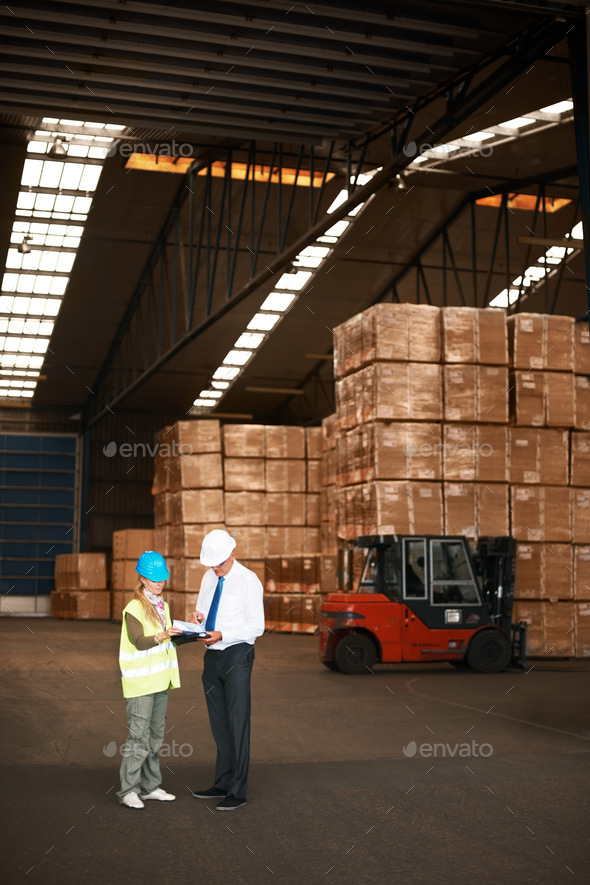 Your goods will have a safe temporary home. Two colleagues talking to one another in a warehouse.