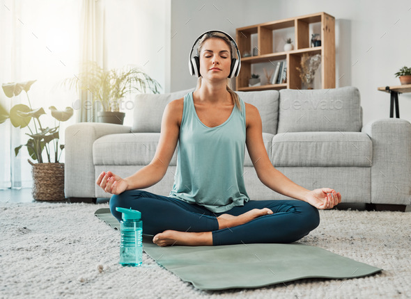 Meditation, fitness and headphones with woman in living room listening to podcast, audio or music t