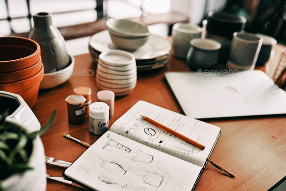 A designers dream. Cropped shot of a potters sketches in a notebook on a work desk in her workshop.