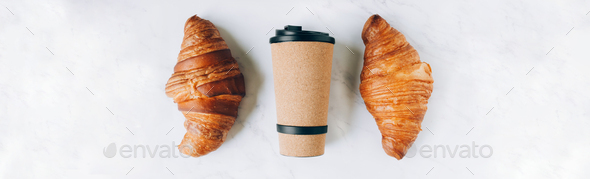Croissants with coffee to go in eco cup, take away breakfast