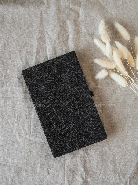 Black pocket journal and dry flowers
