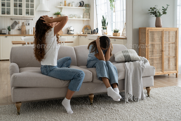 Depressed mother of difficult teen girl daughter feeling sad and frustrated after family fight