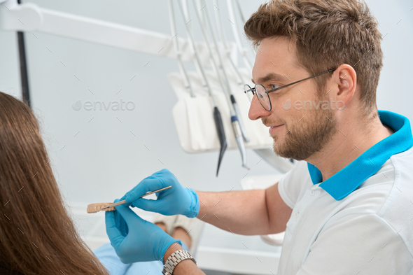 Friendly doctor telling about oral hygiene basics to client