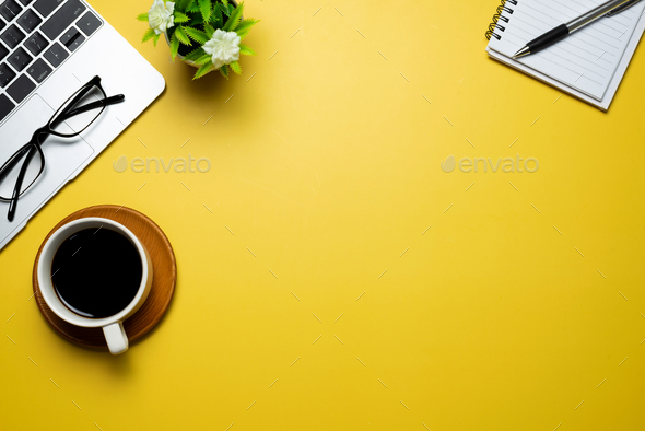 Yellow desk with laptop and accessories other desk copy space. - Stock Photo - Images