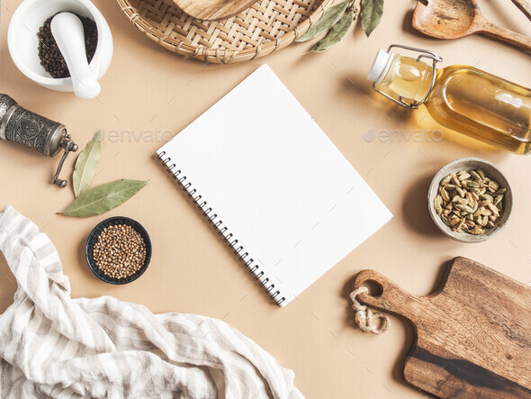 Kitchen flat lay with open notebook for culinary text and small bowls various spices - Stock Photo - Images