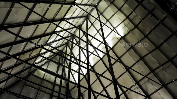 Metal sections of the roof of an industrial warehouse. Stock footage. Bottom view of triangular roof