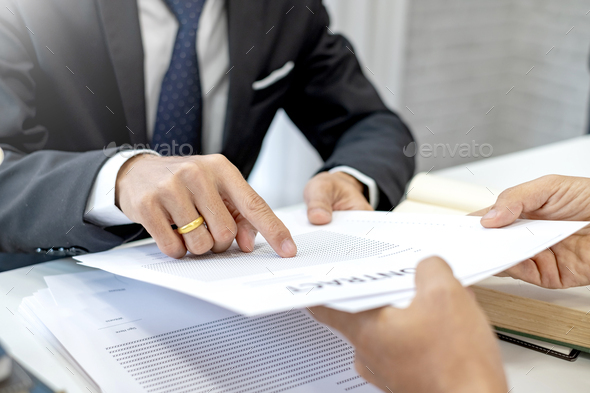 Man in suit pointing the contract document and a job application. Employment and job application.