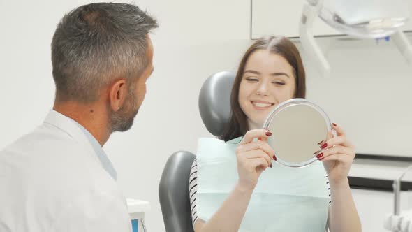 Beautiful Happy Woman Talking To the Dentist After Medical Checkup