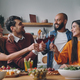 Happy young people toasting with wine while having dinner at home together - PhotoDune Item for Sale