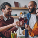 Cheerful young people toasting with wine while having dinner at home together - PhotoDune Item for Sale