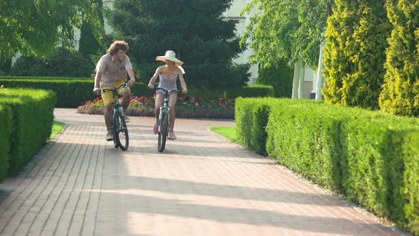 Young Man and Woman Cycling Outdoors alt
