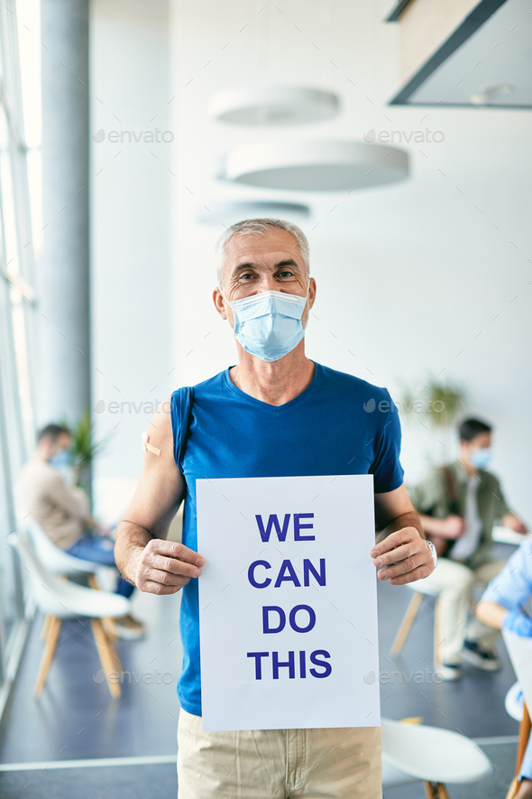Mature man holding placard with \