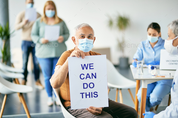 Senior patient holding placard with \