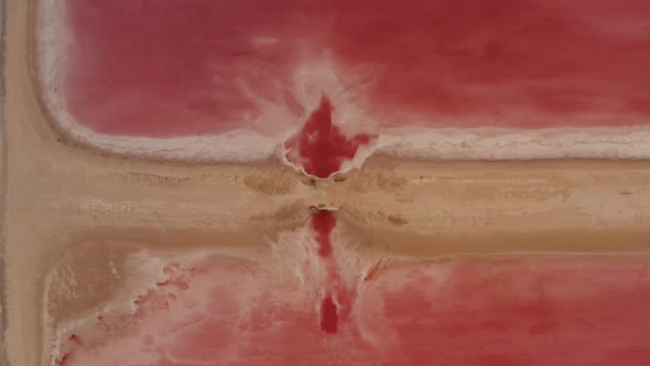 Aerial Birds Eye Overhead Top Down Rising View of Dirt Road Between Pink Lakes alt