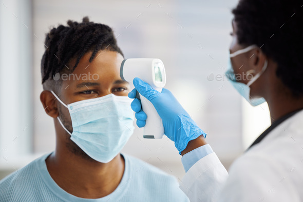 Your temperature seems a bit high. Shot of a female doctor taking the temperature of her patient.