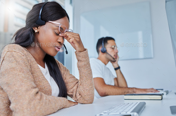 Shot of male and female team members sitting at their desks in their call center office
