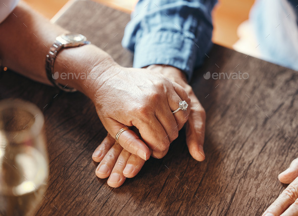 Holding hands, date and couple with support at restaurant for celebration of love, marriage and ann