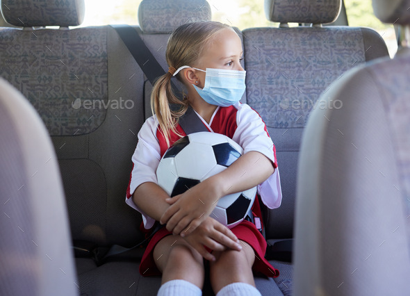 Covid, soccer and girl in a car to travel in backseat to a youth football training game for exercis - Stock Photo - Images