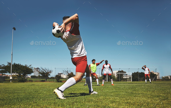 Football throw, soccer and field game of a team in a fitness, exercise and sports match outdoor. Tr