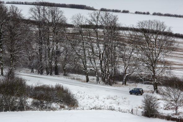 Vehicle on a snow covered country lane - England