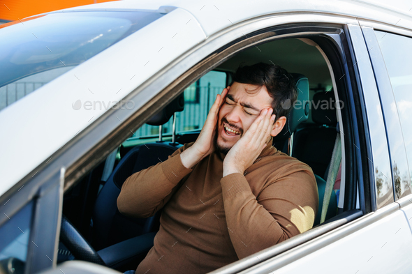 Tired mature driver hand on head waiting in traffic and contemplating about job problems