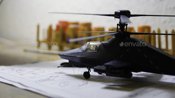 Toy Military Helicopter on wooden table. Small army helicopter hobby model toy on the table. Toy