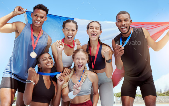 Portrait diverse group of olympic athletes holding winners medals and a French flag. Happy and prou