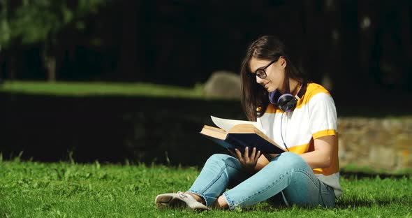 Woman Reading Book in Park