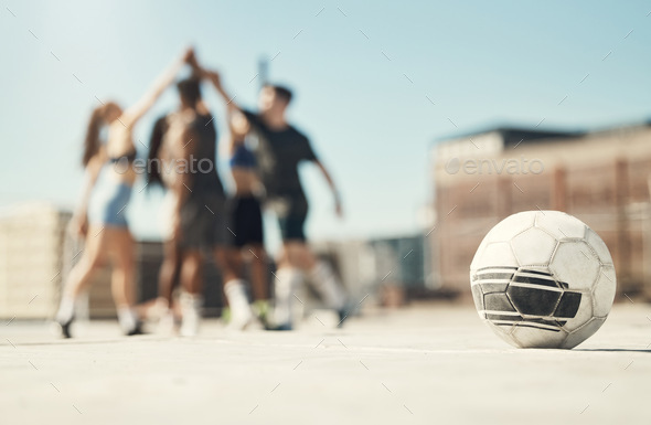 Soccer sports, team building and high five between friends on rooftop in city. Diversity, fitness m