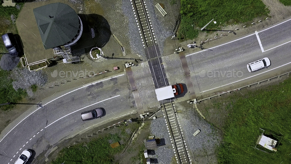 Bird's-eye view. Clip. A long highway with cars around the forest and greenery.
