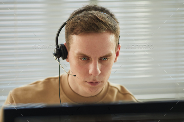 Asian man wearing headset in monitoring and security center