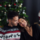 smiling couple cuddling on the sofa at home at christmas time - PhotoDune Item for Sale