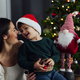 Woman with her child happy at home on christmas - PhotoDune Item for Sale