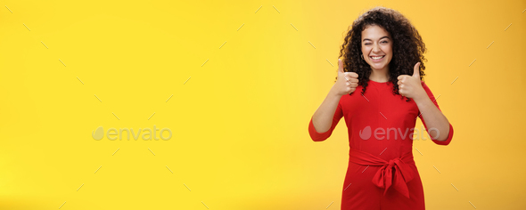 Creative And Charismatic Happy Upbeat Woman 25s With Curly Hair In Red Dress Winking In Approval 8025