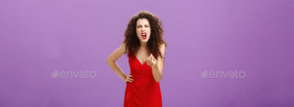 Woman in fury fighting with husband over money making italian gesture with fingers shouting and