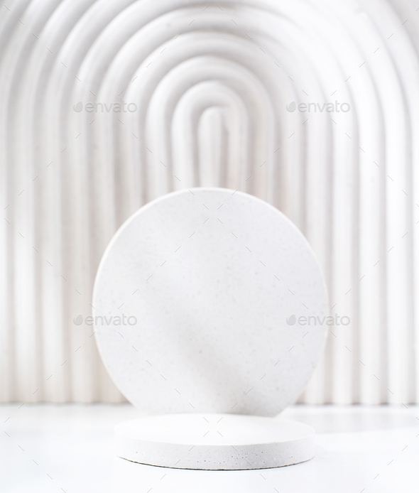 A minimalistic scene of a gypsum podium with stones on white background, for natural cosmetics